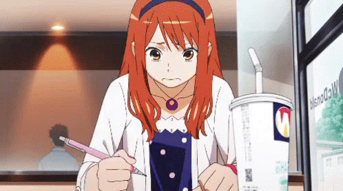 A Girl With Red Hair Is Writing On A Piece Of Paper In Front Of A Cup That Says Mcdonald 'S GIF