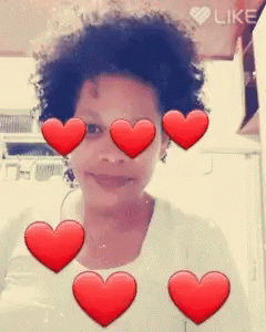 A Girl With Red Hearts Around Her Eyes And The Word Like In The Corner GIF