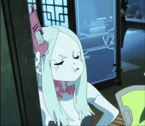 A Girl With White Hair Stands In Front Of A Screen That Says V2 GIF