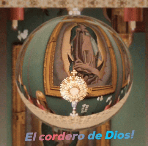 A Glass Ball With A Picture Of Jesus And The Words El Cordero De Dios On It GIF