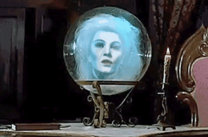 A Glass Ball With A Woman 'S Face In It Is On A Table . GIF