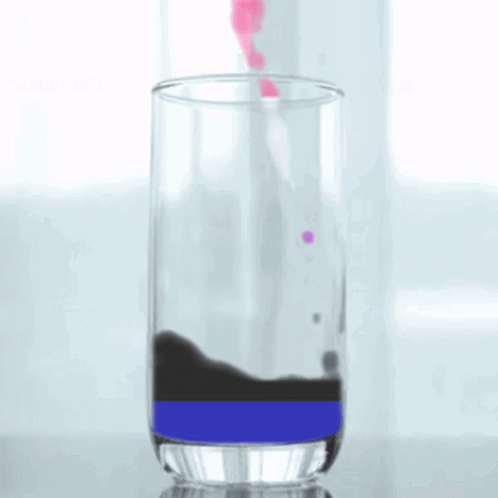 a glass filled with a purple and black liquid
