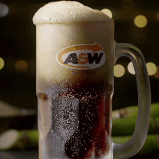 A Glass Mug Of A & W Beer With Foam On Top GIF