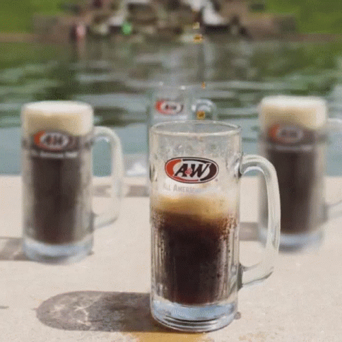 A Glass Of A&w Beer Sits On A Patio GIF