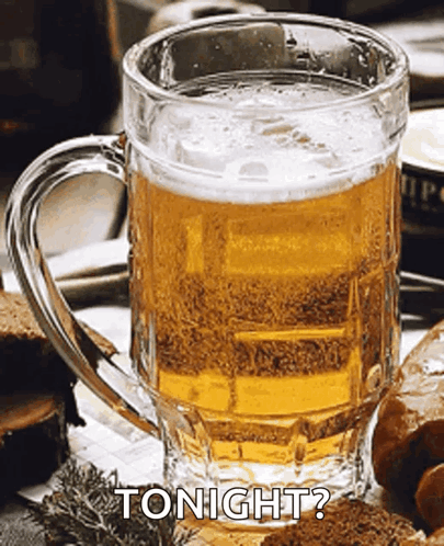 A Glass Of Beer Is Sitting On A Table With The Words Tonight Written Above It GIF