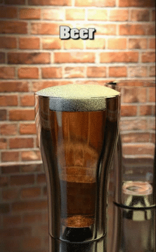 A Glass Of Beer With A Brick Wall In The Background GIF