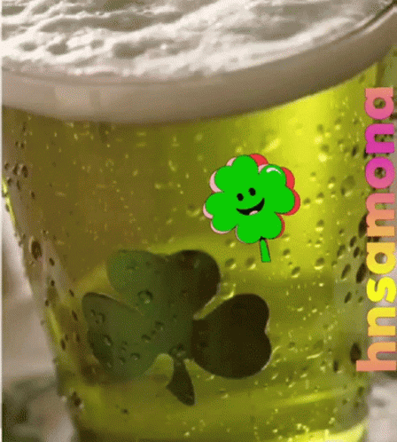 A Glass Of Beer With A Clover And The Word Insana On The Bottom GIF