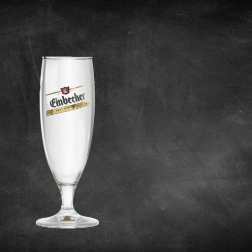 A Glass Of Einbecher Sits On A Blackboard GIF