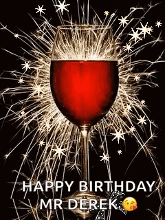 A Glass Of Wine Is Surrounded By Sparklers On A Black Background . GIF