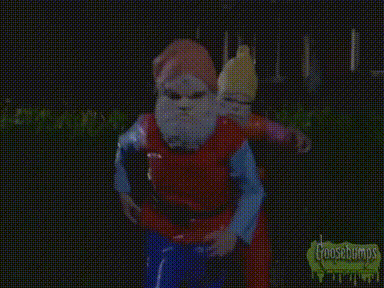A Gnome With A Red Hat And White Beard Is Wearing A Yellow Shirt . GIF