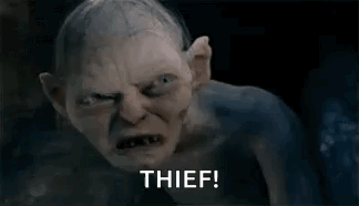A Goblin From The Lord Of The Rings Is Looking At The Camera And Says Thief . GIF