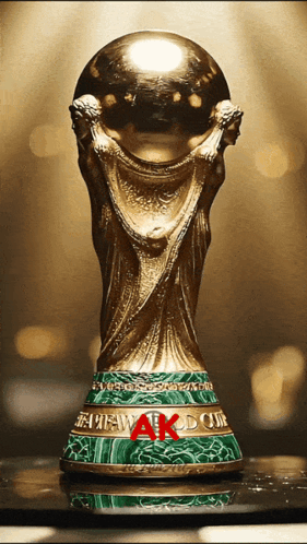 A Gold Trophy With The Word Ak On The Base GIF
