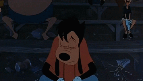 A Goofy Cartoon Character Is Sitting On The Ground With His Hands On His Face GIF
