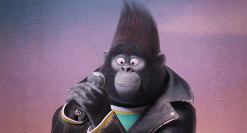 A Gorilla Singing Into A Microphone Wearing A Black Leather Jacket GIF