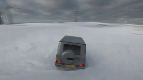 A Gray Suv Is Driving Through A Snowy Field GIF
