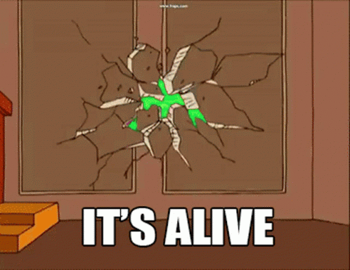 A Green Alien Is Breaking Through A Wall With The Words It 'S Alive GIF