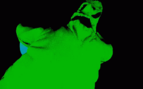 A Green And Black Image Of A Person 'S Face With A Blue Light Coming Out Of It GIF