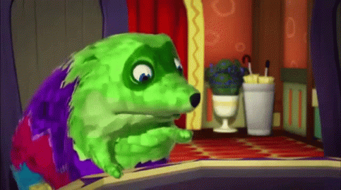 A Green And Purple Cartoon Dog Is Sitting In A Room . GIF