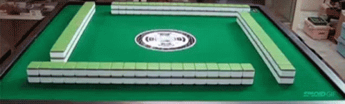 A Green And White Mahjong Board With A White Circle On It GIF