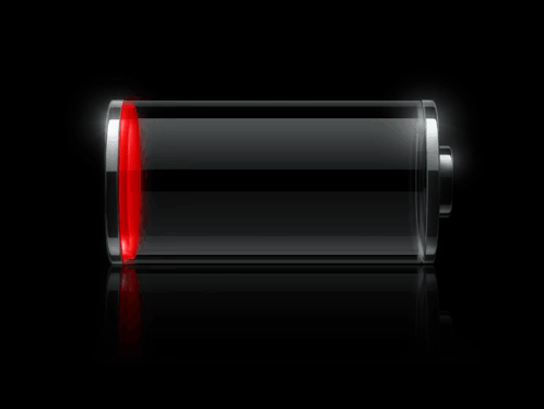 A Green Battery Is Glowing In The Dark On A Black Surface GIF