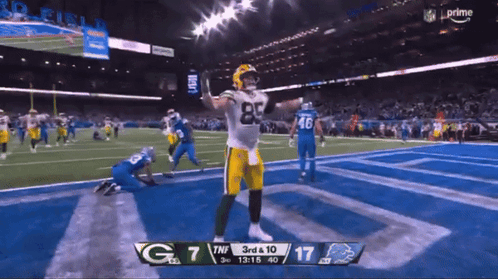 A Green Bay Packers Football Player Celebrates A Touchdown GIF