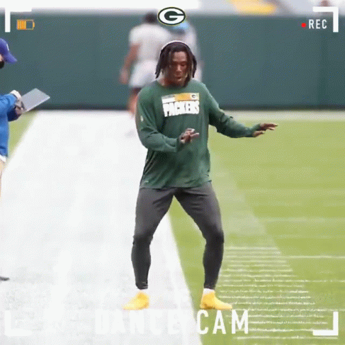 A Green Bay Packers Football Player Is Dancing On The Field GIF