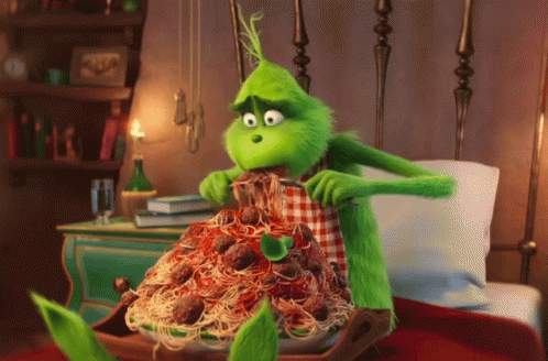 A Green Cartoon Character Is Eating Spaghetti And Meatballs GIF