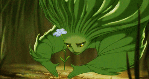 a green cartoon character is holding a small flower
