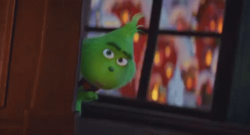A Green Cartoon Character Is Standing In Front Of A Window Looking Out . GIF