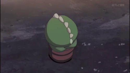 A Green Cartoon Character With Spikes On Its Head Is On A Television Screen GIF