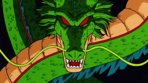 A Green Dragon With Red Eyes And Sharp Teeth Looks At The Camera GIF