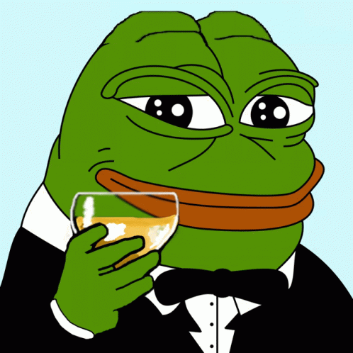 A Green Frog In A Tuxedo Is Holding A Glass Of Orange Liquid GIF
