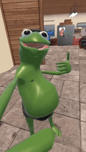 A Green Frog Is Giving A Thumbs Up In A Room GIF