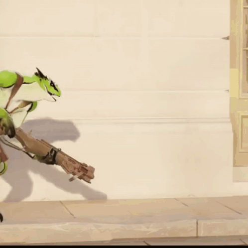 A Green Lizard Is Holding A Gun In Its Hand GIF