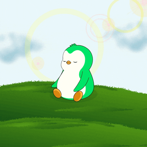 A Green Penguin Sits On A Grassy Hill With Its Eyes Closed GIF