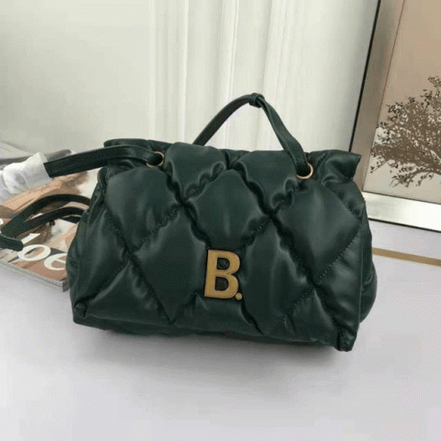 A Green Purse With The Letter B On The Front GIF