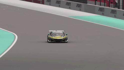 A Green Race Car Is Driving On A Track With Priority Written On The Side GIF