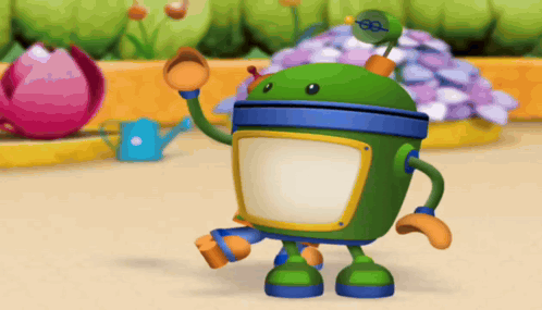 A Green Robot Is Standing In Front Of A Flower Bed GIF