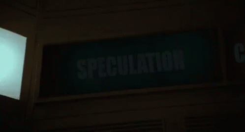 a green sign that says speculation is lit up at night