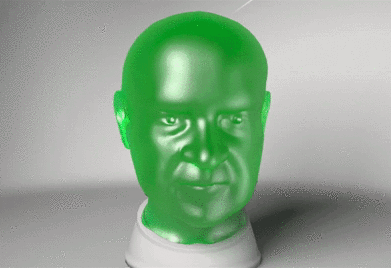 A Green Statue Of A Man 'S Head Is Sitting On A White Base GIF