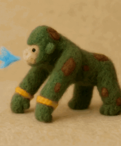 Green Stuffed Gorilla With Brown Spots GIF