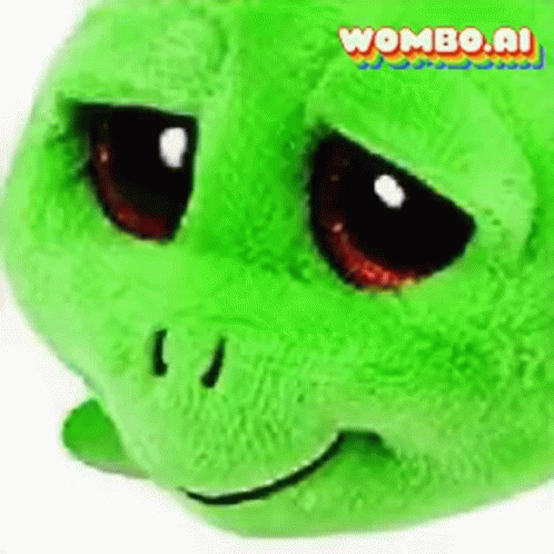 A Green Stuffed Turtle With A Sad Look On Its Face Is Sitting On A White Surface . GIF