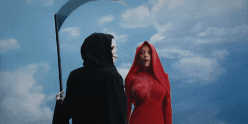 A Grim Reaper Holding A Scythe And A Woman In A Red Dress GIF