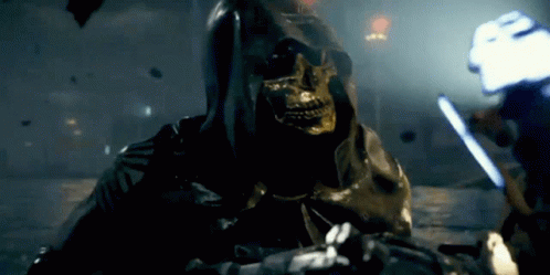 A Grim Reaper With A Skull On His Face Is Holding A Sword GIF