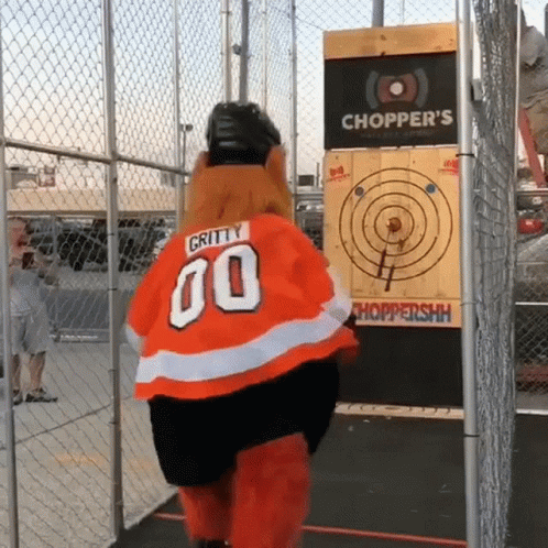 A Gritty 00 Mascot Is Standing In Front Of A Chopper 'S Target GIF