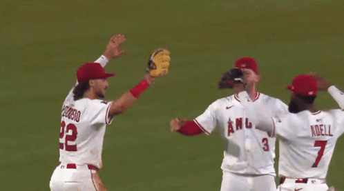 A Group Of Angels Baseball Players Celebrate Together GIF