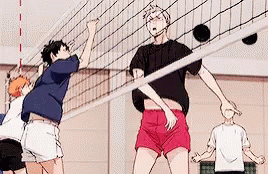a group of anime characters are playing volleyball in a gym .