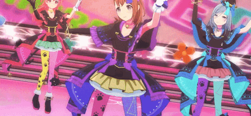 a group of anime girls are dancing on a stage .