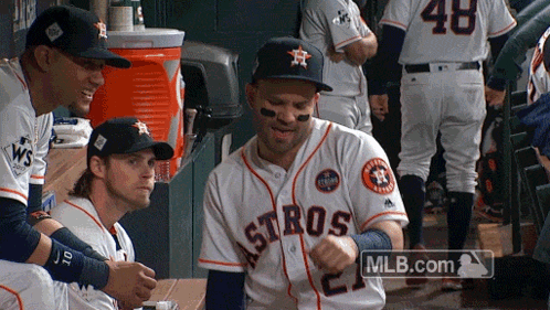 A Group Of Astros Players Are Sitting In The Dugout GIF