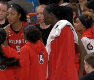 a group of atlanta basketball players are standing in a crowd
